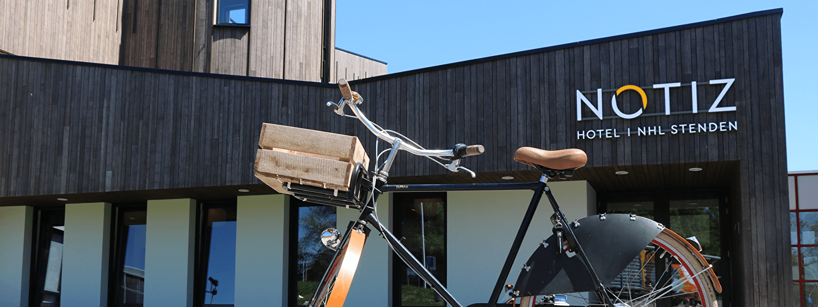 Couple reading an information board during a cycling tour through nature in Friesland, Netherlands.